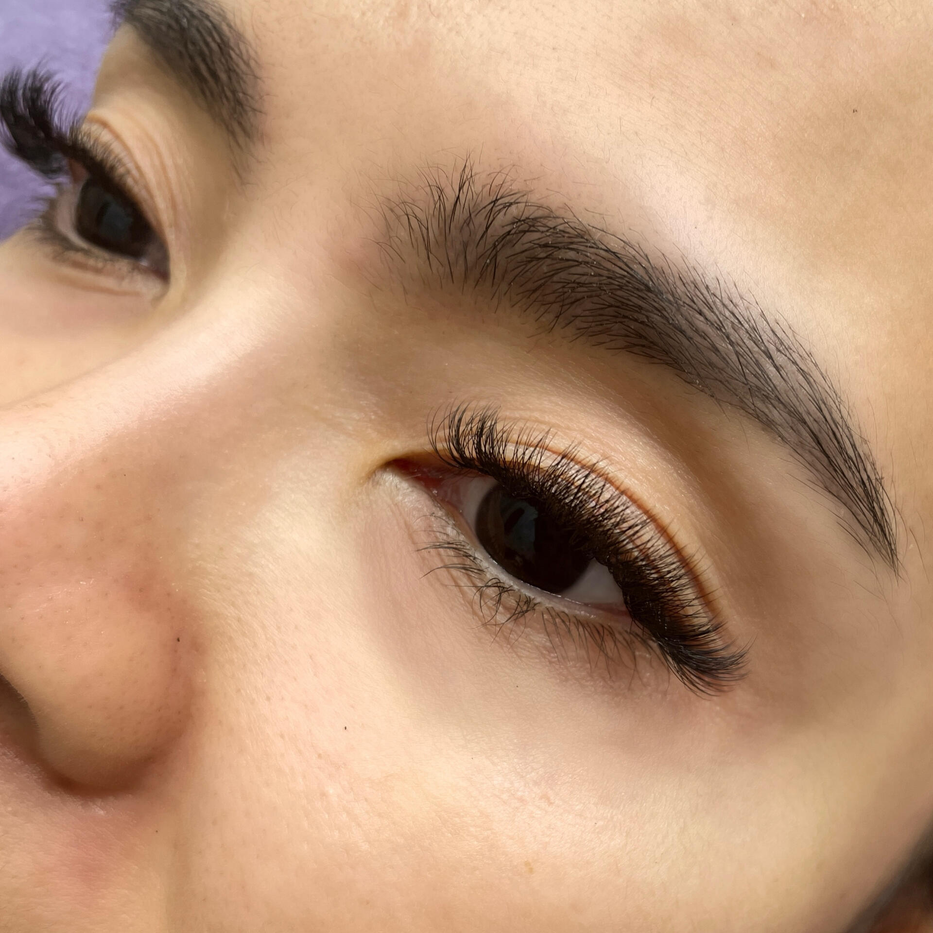 fluffy, natural volume lash extensions on asian eyes